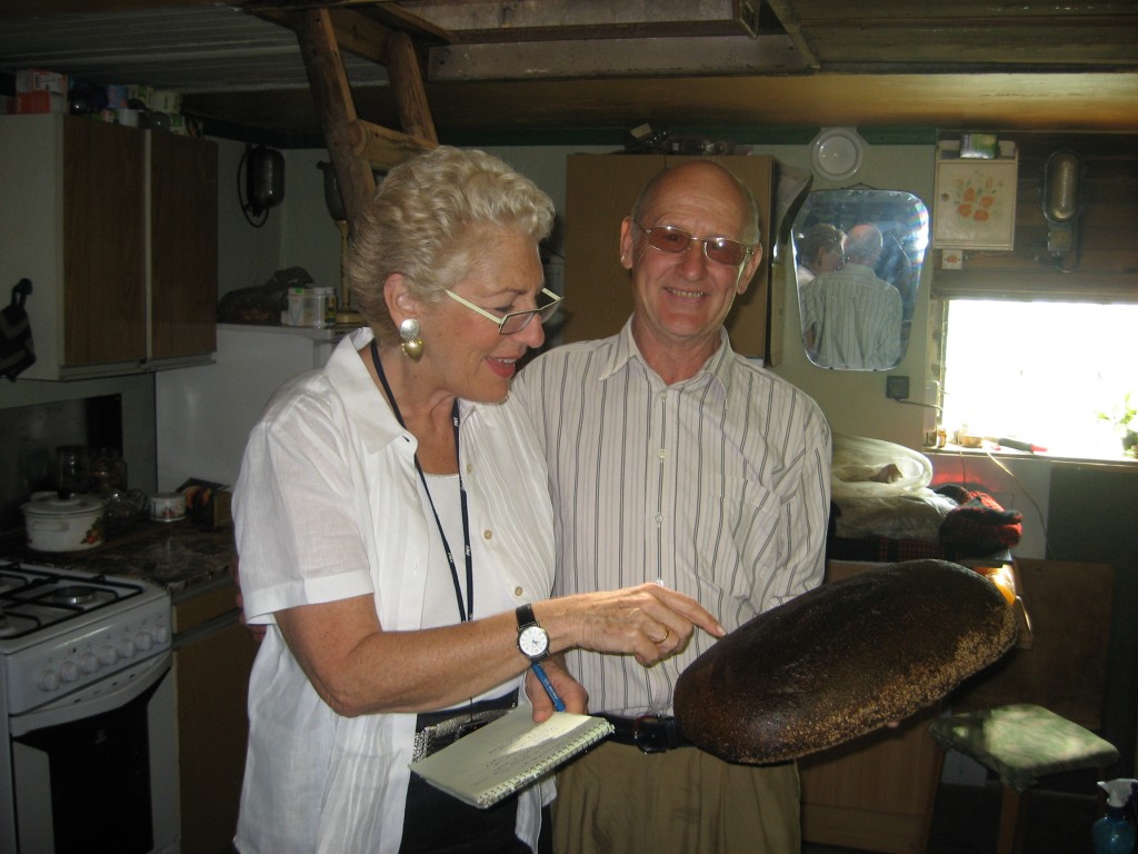 Michaele Weissman looking at a freshly baked loaf of bread with Aivars.